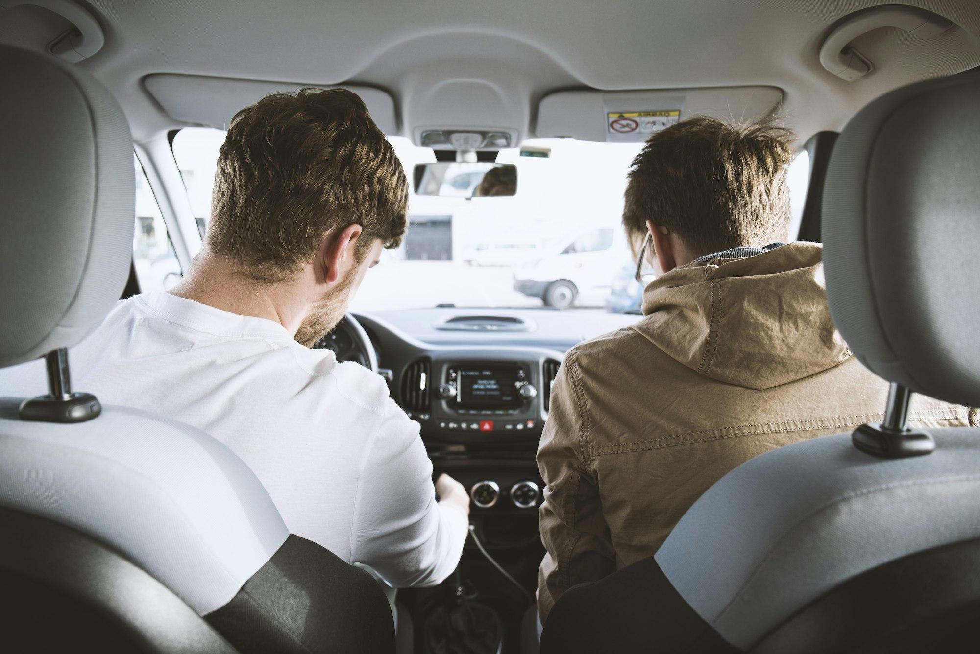 Learner driver at the wheel with their instructor beside them